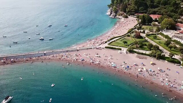 A drone video from above on the beach of the island of Sveti Stefan in Montenegro