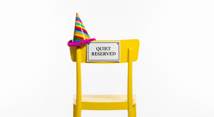 Colorful Party Hat on Reserved Yellow Chair for Quiet Celebrations and Events