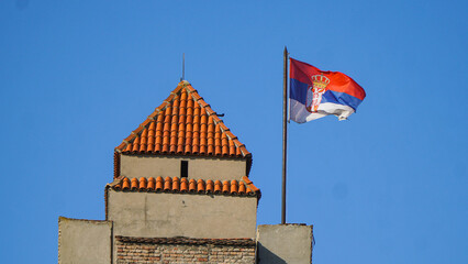The tower of the military museum on Kalemegdan with the Serbian national flag.
