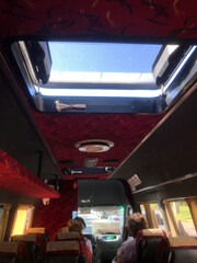 Unique interior view of a bus with skylight during a trip