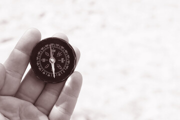 Classic navigation compass on natural background
