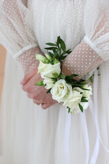 A rose flower decoration on a girl's wrist.