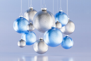 Glossy 3D baubles hanging in a light winter scene