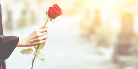 Holding a rose in remembrance at a solemn funeral gathering