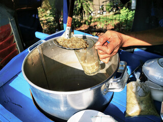 Traditional Indonesian green bean or mung bean porridge (bubur kacang hijau) being served fresh...
