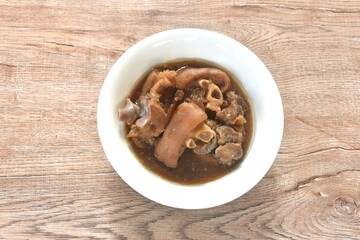 boiled braised salty pork leg in Chinese herb brown soup in bowl 