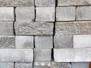 Stacked cement road curbs, broken and intact