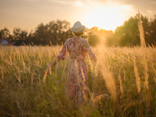 boho chic woman in a floral dress in European countryside