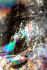 Beautiful close up of quartz crystal rock shard with reflective rainbow spiritual light