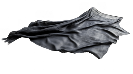 The soft black fabric flows gracefully across a white surface, highlighting its texture and elegant form
