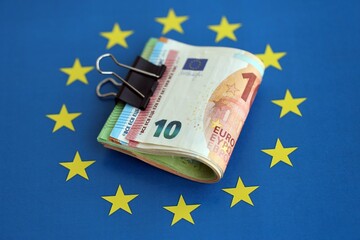 European euro currency money notes bunch on Europe union blue flag close up