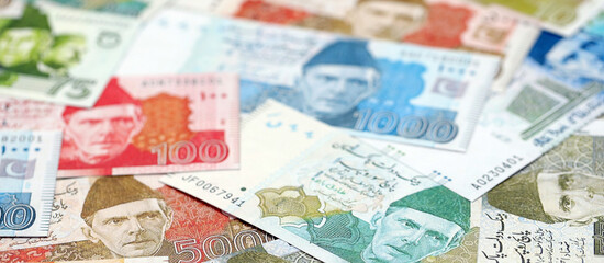 Pakistan rupees banknotes. The current Pakistan money bills lies on table in big amount