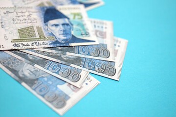 Pakistan rupees banknotes on blue background. The current Pakistan money bills