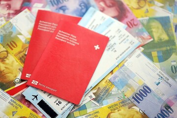 Swiss franc banknotes and passport with tickets. The current francs money bills and biometrical pass