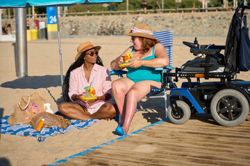 Multiracial friends enjoying summer cocktails on the beach