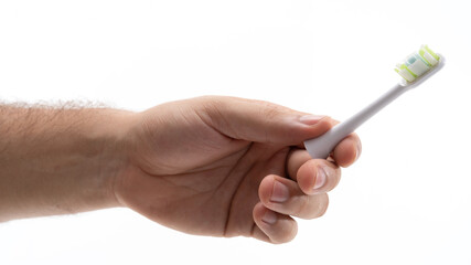 Hand holding a toothbrush with a replaceable head