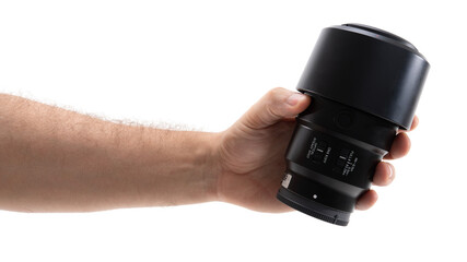 Hand holding a camera lens in bright light