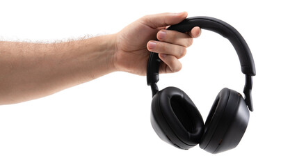 Hand holds black headphones on a white background