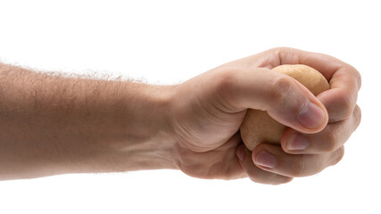 Hand squeezing a small object with focus on grip