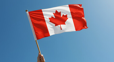 Canadian Flag Waving Proudly Against a Bright Blue Sky