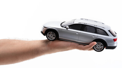 Hand holding a model car with detailed design