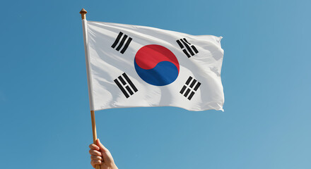 Waving South Korean Flag Held Against Clear Blue Sky