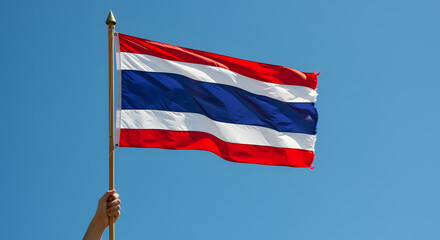 Thai National Flag Waving in Clear Blue Sky, Held by Hand &ndash; Patriotism, Travel, and Culture