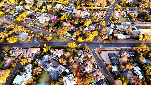 Sunset aerial over Randburg residential neighborhood with trees in autumn colors