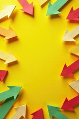 Chaotic yellow background with overlapping, crisscrossing paper arrows , folded, pointed, direction