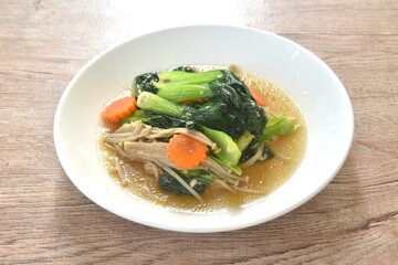 stir fried Chinese cabbage with needles mushroom and carrot in soy sauce on plate