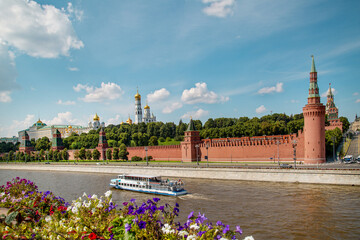 View of the Kremlin from the Moskva River with flowers on a clear sunny day, Moscow.  Sights of Russia. Architecture of World tourism.