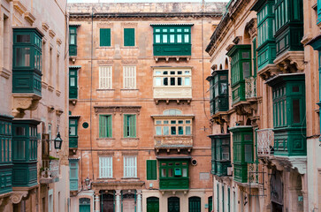 Historic Maltese buildings with traditional green wooden balconies