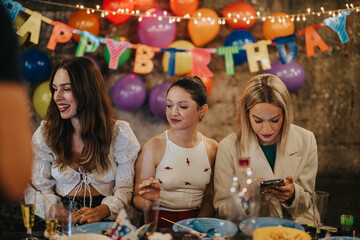 Three women enjoy a festive birthday celebration with colorful balloons, lively decorations, and delicious food. A backdrop of warmth and joy enhances the event's special and cherished moments.