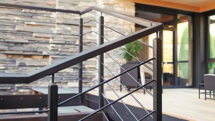 Modern staircase with metal handrails and wooden steps in contemporary interior design