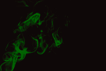 Abstract green smoke swirling on black background