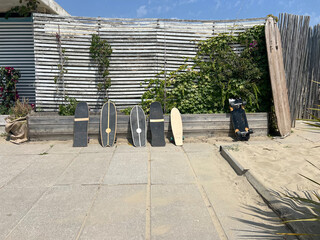 Wooden skateboards lined up on beachside pavement