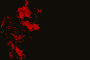 Vibrant red smoke swirling on black background