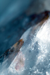Beautiful close up of quartz crystal rock shard with reflective rainbow spiritual light