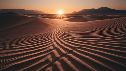 Naklejka premium Rippled Sand Dunes at Sunset with Distant Mountains and Golden Light desert landscape
