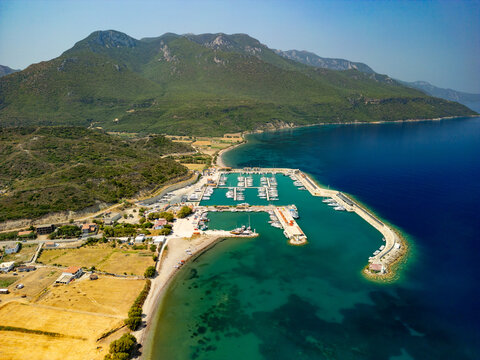 Aerial view of boats nestled in Kormen Marina's tranquil waters against a backdrop of verdant hills and turquoise sea, Datca, Mugla, T&Atilde;&frac14;rkiye.