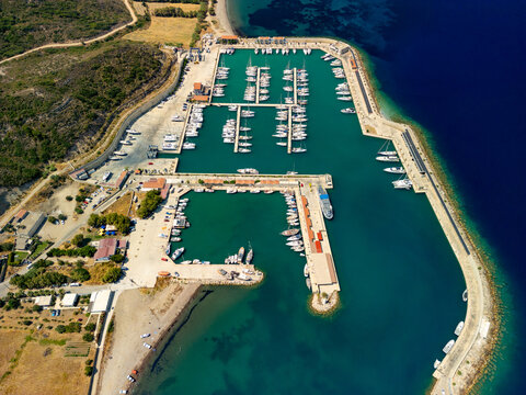 Aerial view of boats docked neatly in Kormen Marina, where the turquoise waters meet the rugged coastline, Datca, Mugla, T&Atilde;&frac14;rkiye.