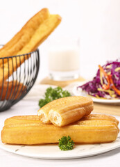 Delicious crispy fried doughnuts perfect for a delightful breakfast snack experience at a cozy cafe