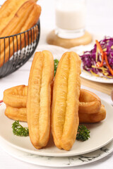Delicious traditional breakfast doughnuts served with fresh salad and milk in a cozy setting