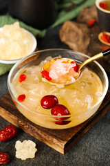 Bowl of delicious icesugar silver ear soup with red dates and goji berries presented elegantly at a dining table