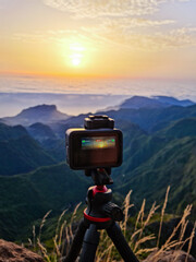  An action camera on a tripod capturing a
mountain landscape at sunrise.