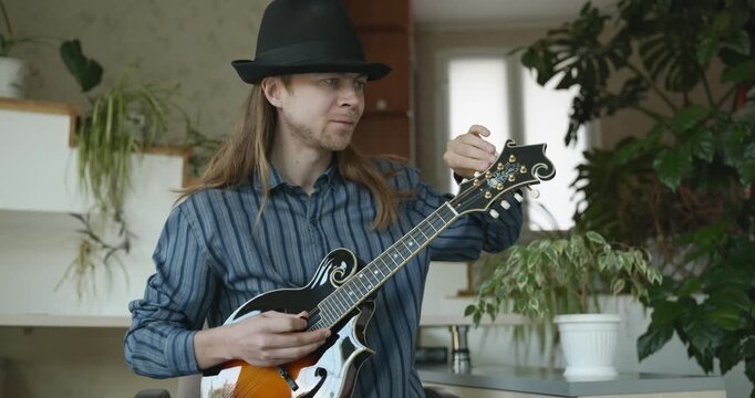 Male Musician Plays Mandolin. Caucasian Man Enjoys Playing Music 4K 10-bit