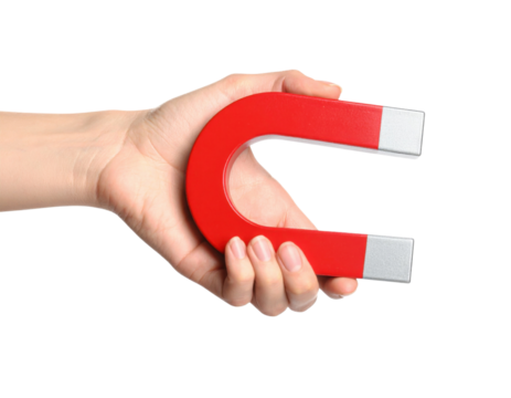 A hand holding a red horseshoe magnet with silver ends, representing magnetism and attraction. - Powered by Adobe