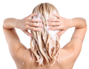 A person with long, blonde hair washing their hair, using both hands to apply shampoo and ensure thorough cleansing.