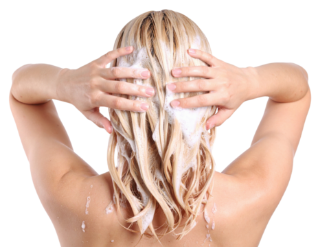 A person with long, blonde hair washing their hair, using both hands to apply shampoo and ensure thorough cleansing.