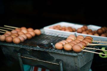 Grilling delicious egg skewers street market food photography urban setting close-up culinary delight